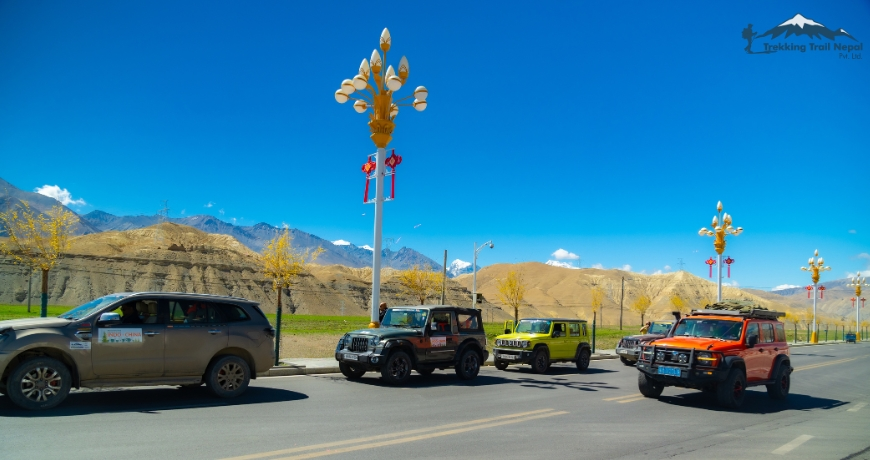 Convoy crossing small tibetan town